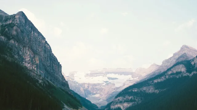 A mountain lake between two snow-covered slopes.