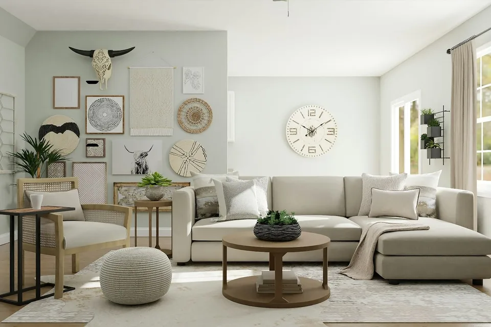 A pale sitting room with a sofa, a low table and pictures on the walls.