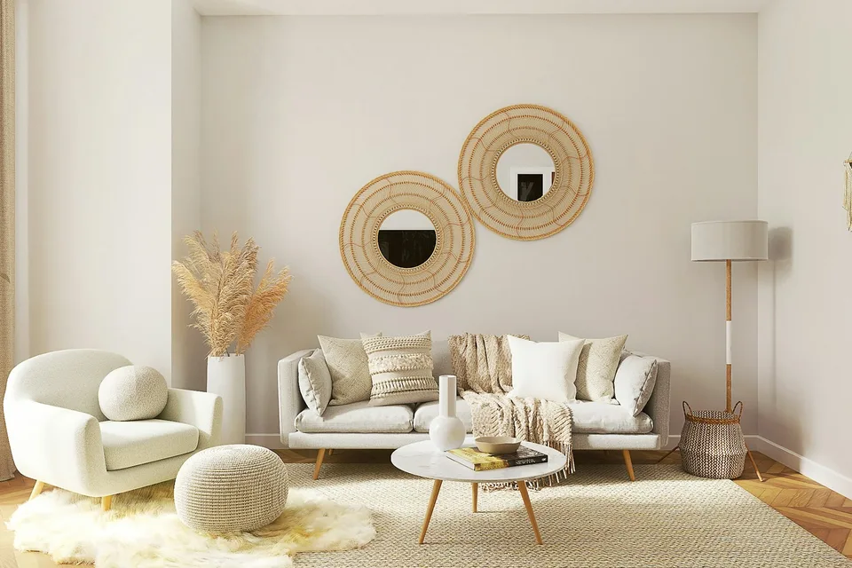 A white room with round mirrors and a pale sofa.